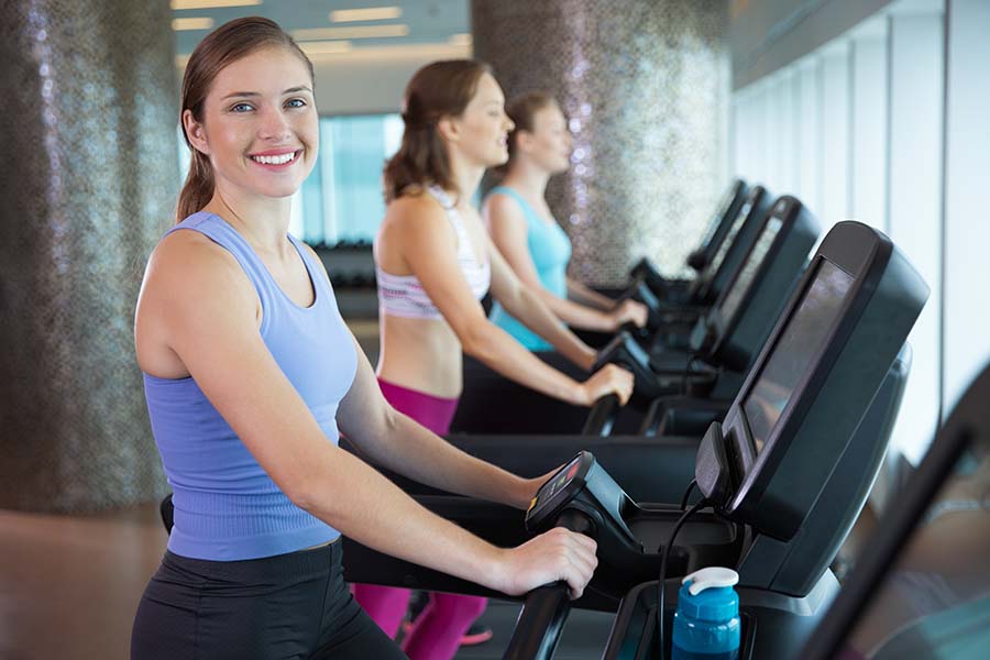 women on cardio machines working out